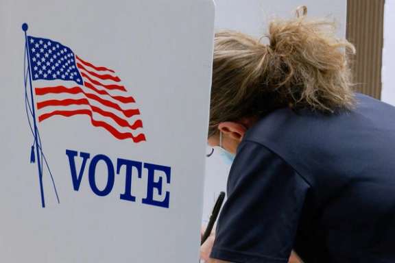 A voter marks a ballot during the primary election and abortion referendum at a Wyandotte County polling station in Kansas City, Kansas, US August 2, 2022.