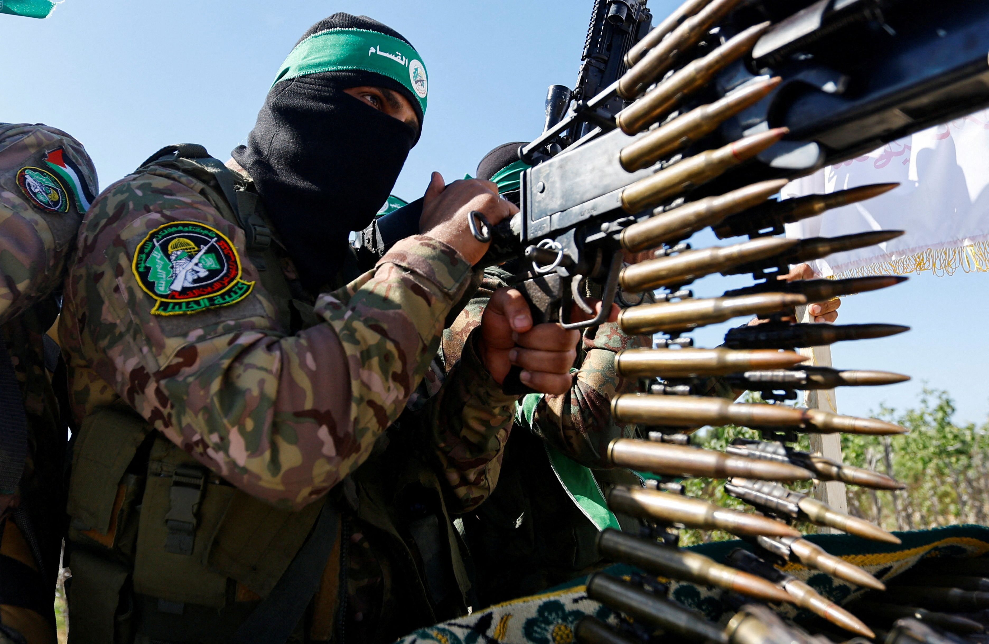A Palestinian fighter from the armed wing of Hamas takes part in a military parade to mark the anniversary of the 2014 war with Israel, near the border in the central Gaza Strip, July 19, 2023. 