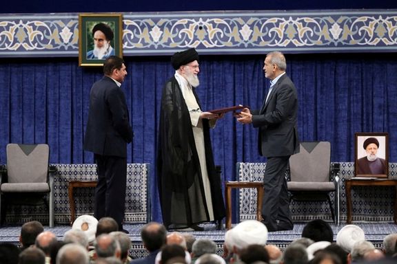 Iran's Supreme Leader Ali Khamenei gives a Presidential decree to Iran's new president, Masoud Pezeshkian, during an endorsement ceremony in Tehran, Iran, July 28, 2024.