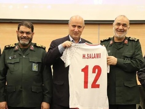 Iran's football chief Mehdi Taj presents a National Team jersey to slain, then IRGC commander, Hossein Salami