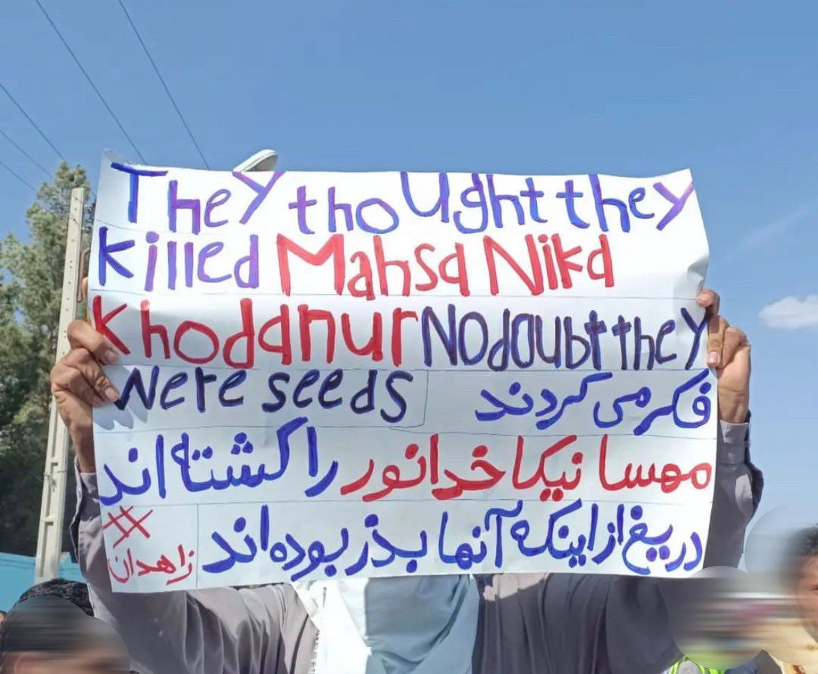 A protester holding a placard during the rally in Zahedan on February 24, 2023 