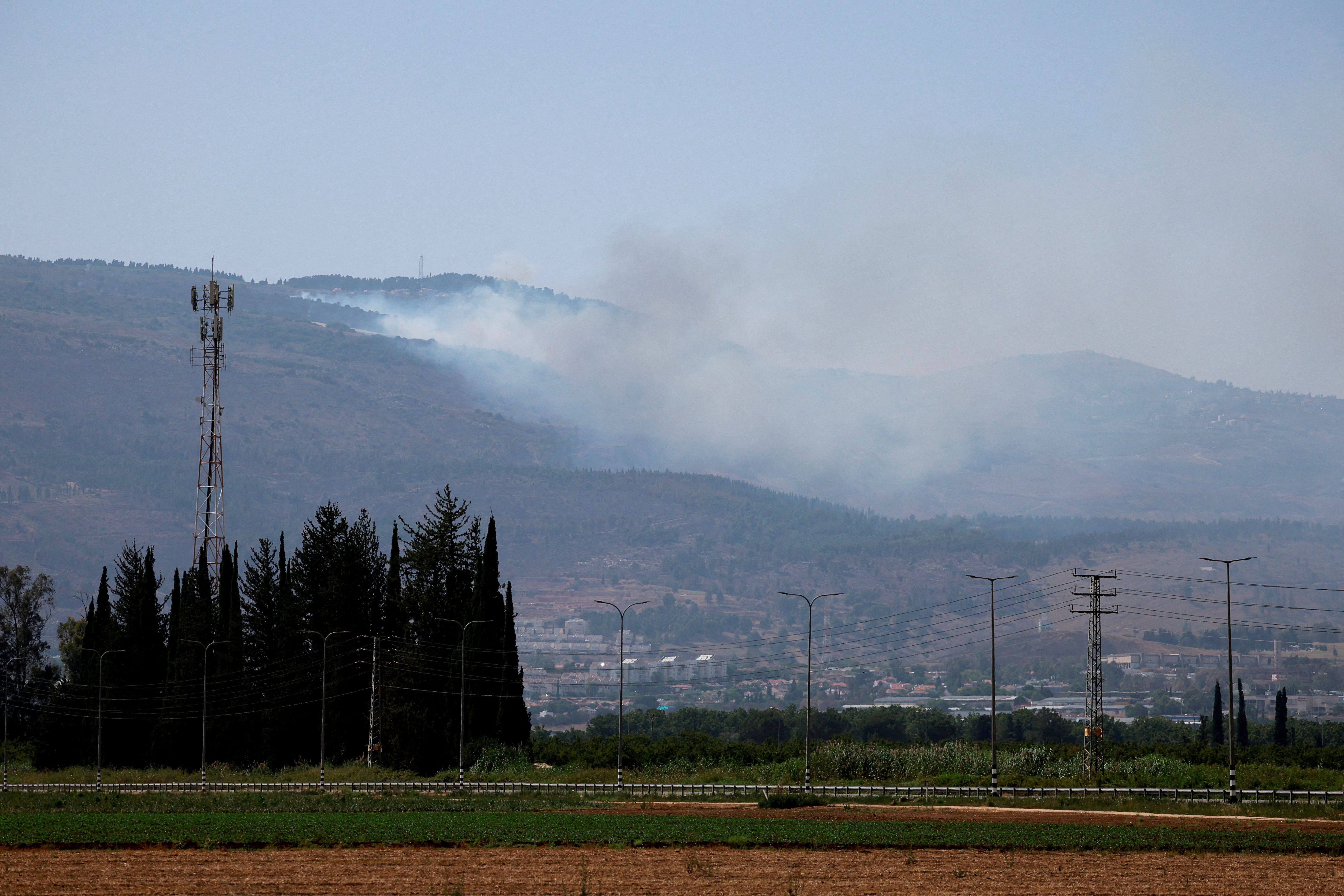 Smoke rises, amid ongoing cross-border hostilities between Hezbollah and Israeli forces, in Kiryat Shmona, northern Israel, June 14, 2024. 