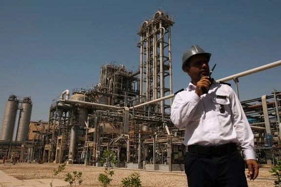 A security person stands in front of the Mahshahr petrochemical plant in Khuzestan province,1032 km (641 miles) southwest of Tehran, September 28, 2011.