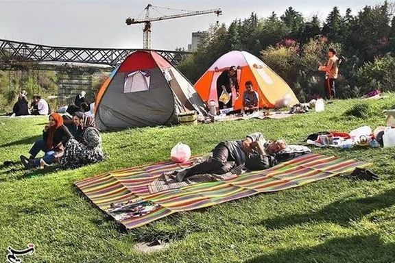 Iranian travelers setting up camp at parks during Nowruz holidays
