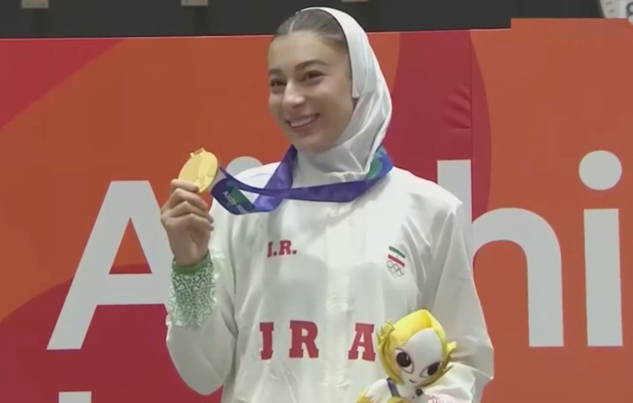 Saghar Moradi Sheikhlari celebrates with her gold medal after winning the women’s under-67kg taekwondo title.