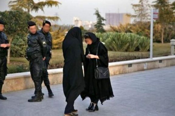A hijab enforcer team confronting a woman on streets