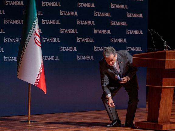 Iranian Foreign Minister Abbas Araqhchi leans to pick up a dropped thing after a press conference in Istanbul, Turkey, June 22, 2025.