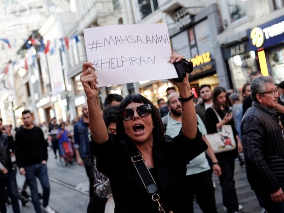 A demonstrator shouts slogans while holding up a sign during a protest in solidarity with women in Iran in central Istanbul, Turkey September 20, 2022.