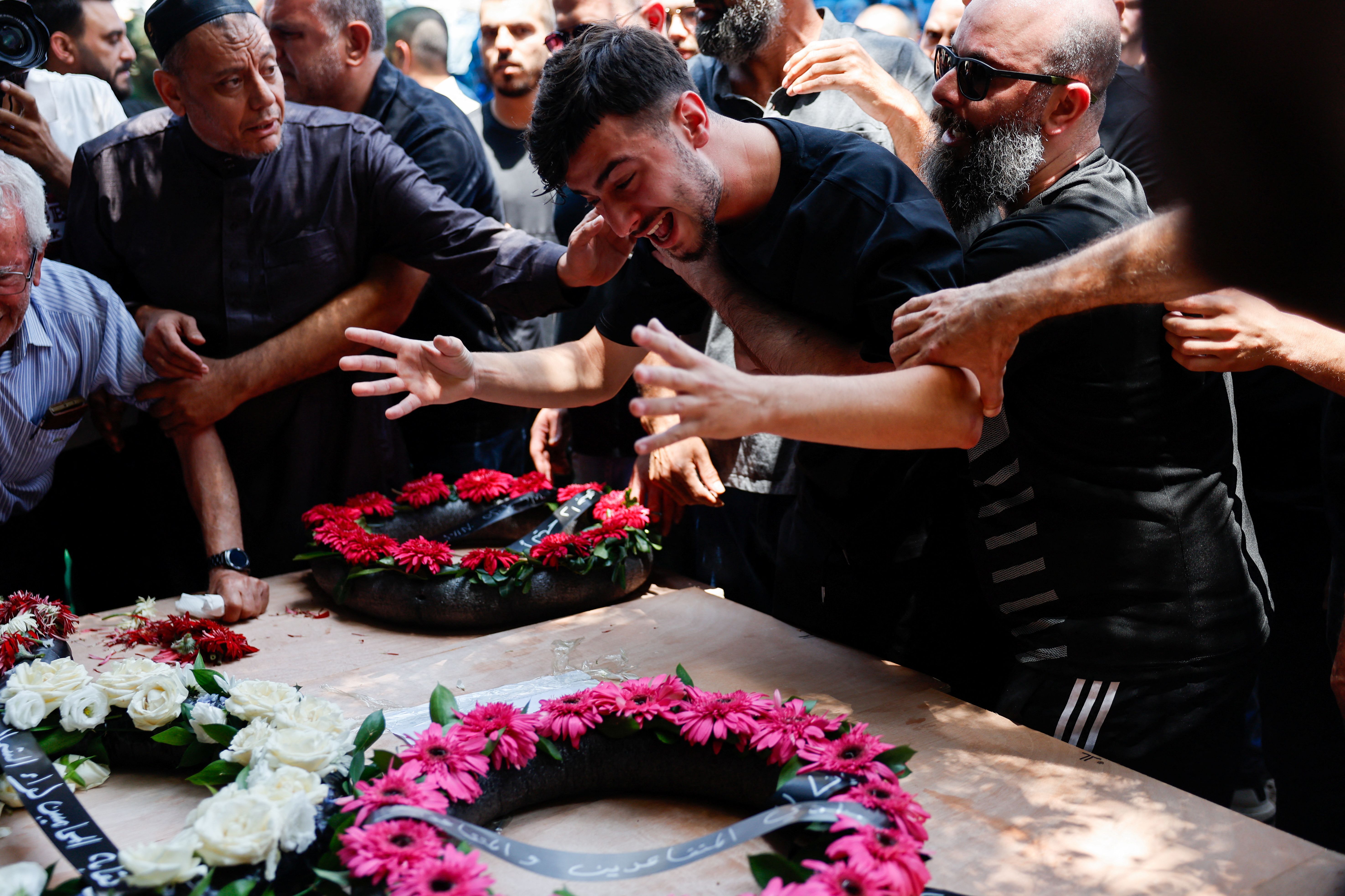 A man reacts as relatives and friends attend the funeral of Manar Khatib and her two daughters, Hala, 20, and Shada, 13, and their relative, Manar Khatib who were killed during a missile attack from Iran on Israel, in Tamra, north Israel June 17, 2025