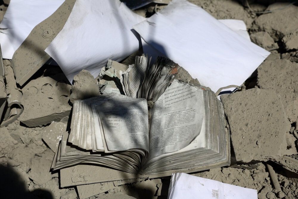 A damaged book lies among rubble at Tehran’s Sharif University of Technology following US-Israeli strikes, April 7, 2026