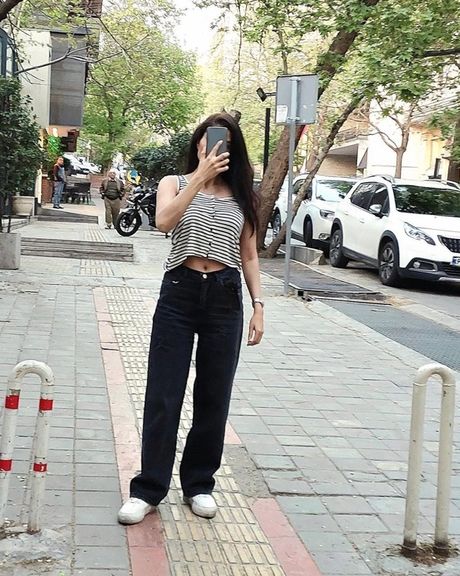 An Iranian woman unveiling in public