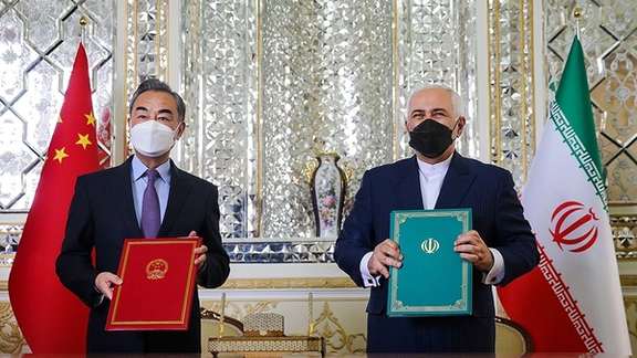 Former foreign minister Javad Zarif and his Chinese counterpart exchanging the text of a long-term agreement in March 2021