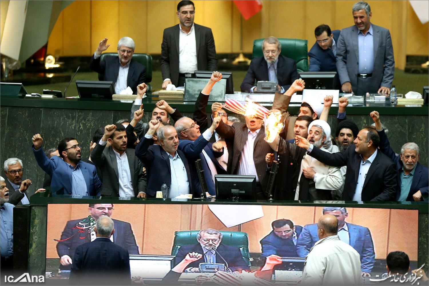 Members of the Iranian parliament set fire to a US flag