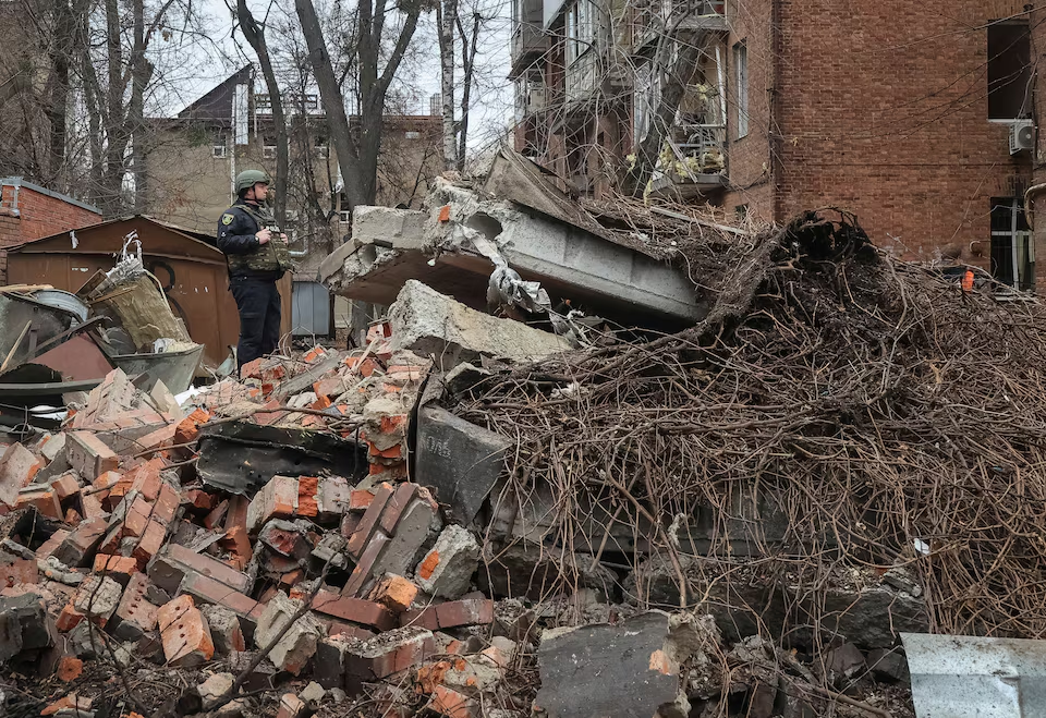 A police officer stands at a site of apartment buildings hit by a Russian missile strike, amid Russia's attack on Ukraine, in Kharkiv, Ukraine November 25, 2024.