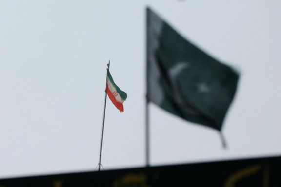 The flag of Iran is seen over its consulate building with Pakistan's flag in the foreground