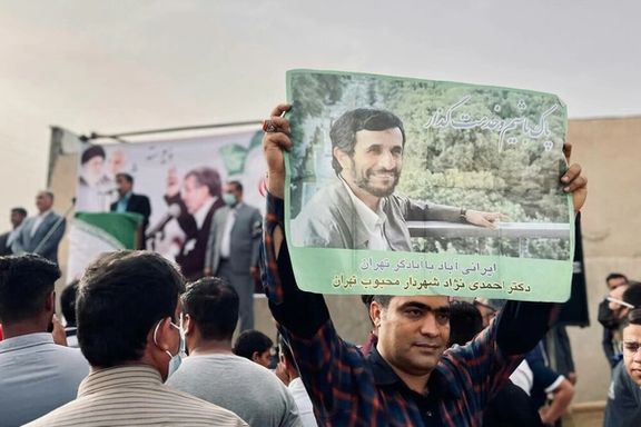 Supporters of Mahmoud Ahmadinejad with his posters in May 2021
