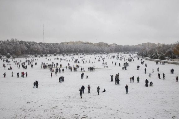 People walk across the snow-covered bed of the dried rive Zayandeh Roud in Isfahan after the season’s first snowfall, Iran, December 16, 2025