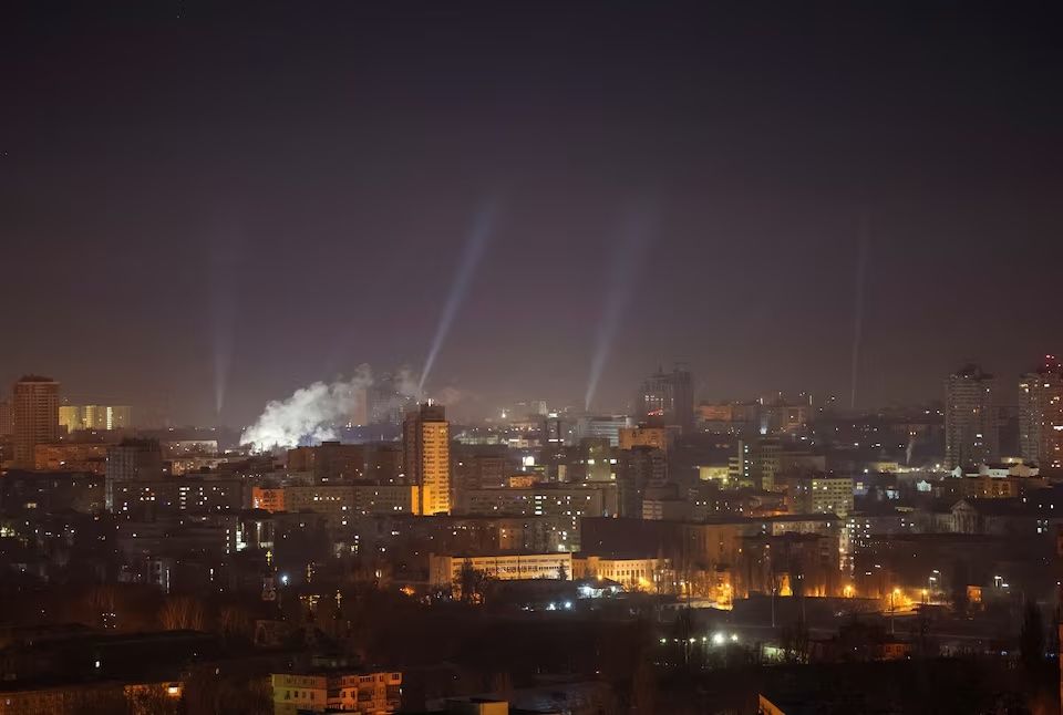 Ukrainian service personnel use searchlights as they search for drones in the sky over the city during a Russian drone strike, amid Russia's attack on Ukraine, in Kyiv, Ukraine February 23, 2025