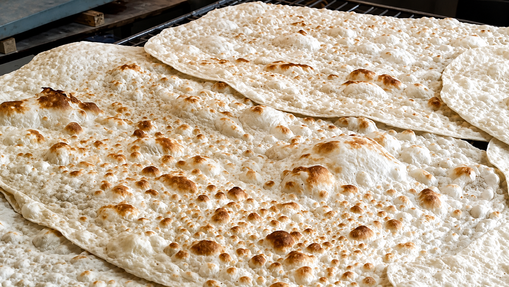 Freshly baked lavash bread is displayed at a bakery in Iran.