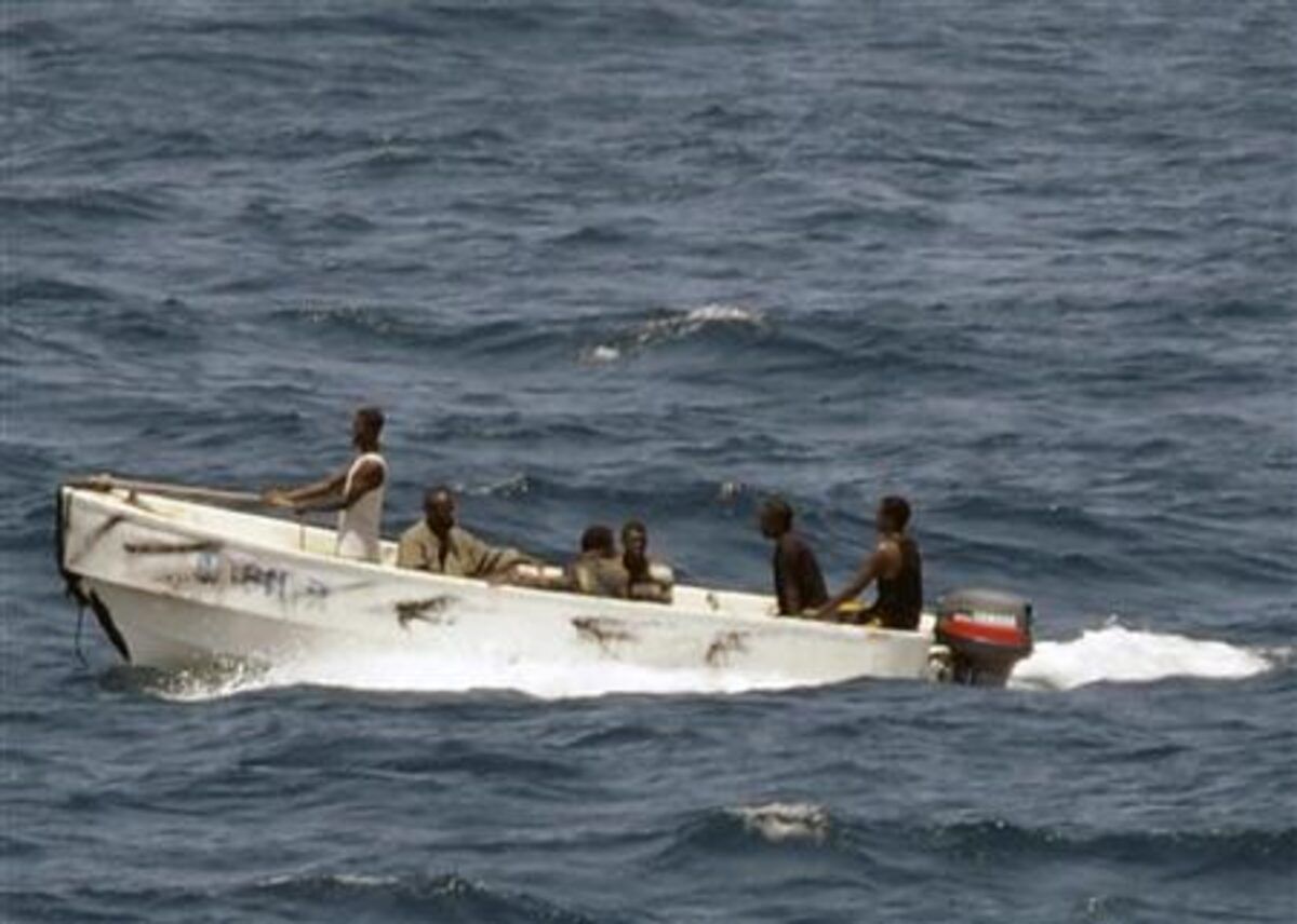 Pirates leave the merchant vessel MV Faina (not shown) for the Somali shore, while under observation by a U.S. Navy ship, October 8, 2008