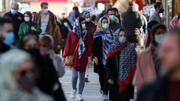 People walking in a Tehran street. Undated