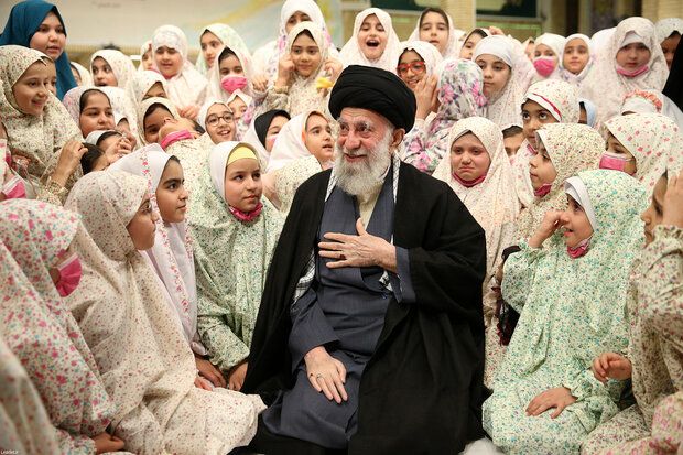 Iran’s ruler Ali Khamenei among a group of schoolgirls   (undated)