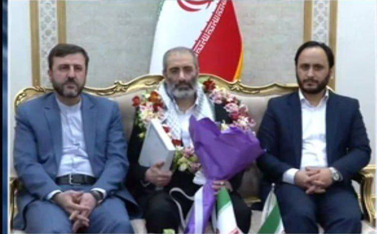 Assadollah Assadi (center) received a hero's welcome by government spokesman Ali Bahadori Jahromi (right) and Kazem Gharibabadi, the deputy head of the Judiciary who is also secretary of the High Council for Human Rights as well as several other officials. (May 26, 2023)