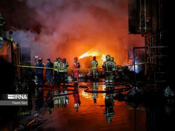 Firefighters work at the scene of a large fire in a warehouse complex in southern Tehran, April 25, 2024
