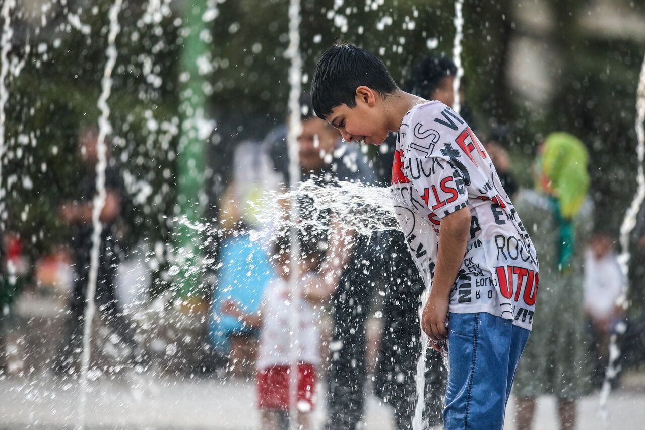 Kids cool down at a park's fountains, Tehran, Iran, August 23, 2025