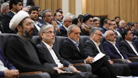 Iran's President Masoud Pezeshkian (center, taking notes) and Science Minister Hossein Simayi Sarraf (sitting to his right) during a ceremony on October 12, 2024.