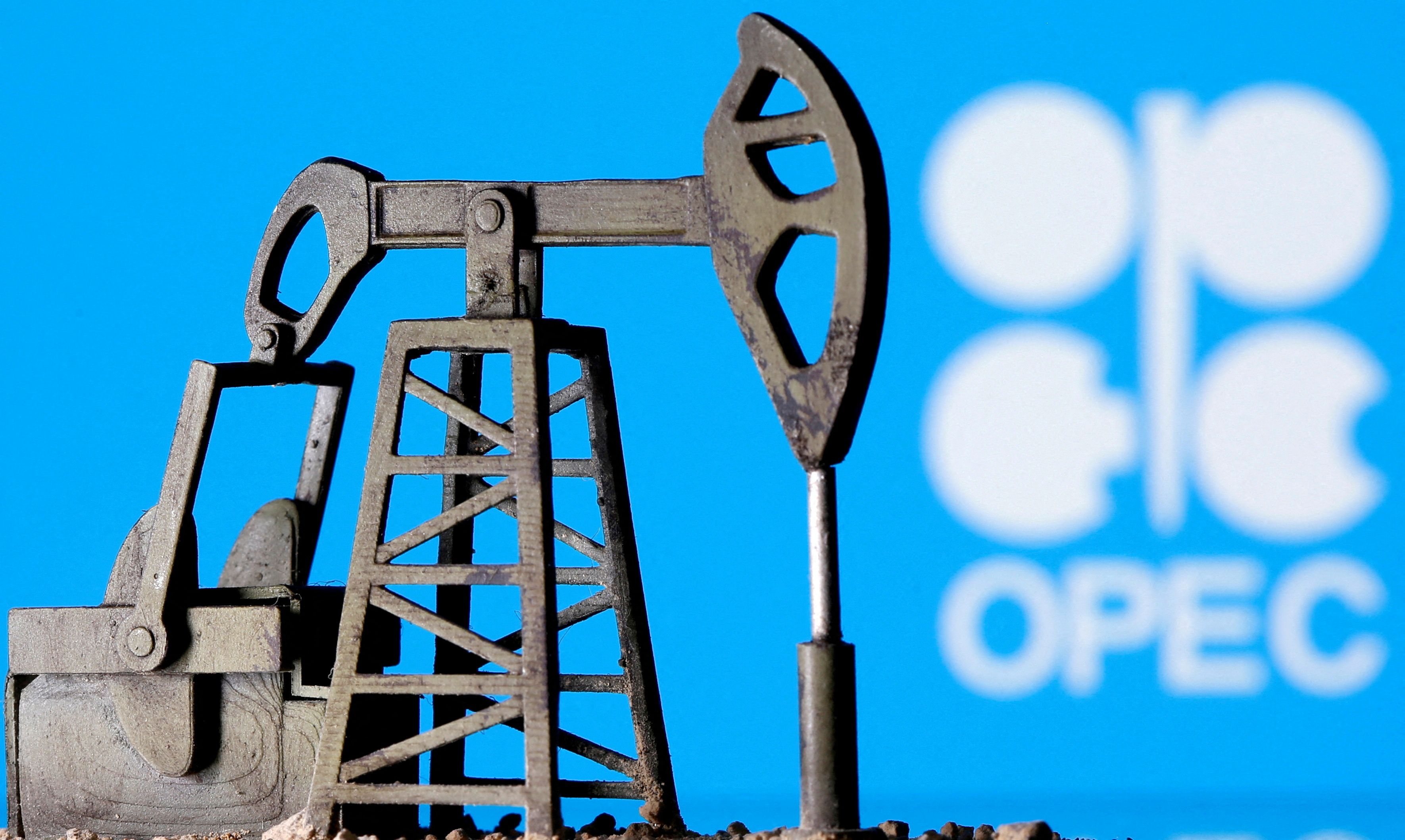 A 3D-printed oil pump jack is seen in front of the OPEC logo in this illustration picture (April 14, 2020)