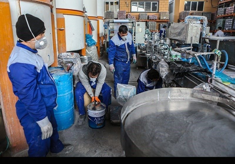 کارگران در حال کار در یک کارگاه رنگ در تهران
