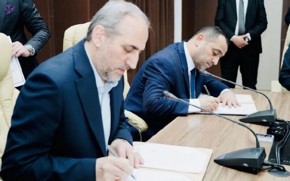 National Iranian Gas Company CEO Majid Chegeni (left) and Iraq's Ministry of Electricity Ziad Ali Fadhel signing a five-year barter deal in Baghdad on March 27, 2024