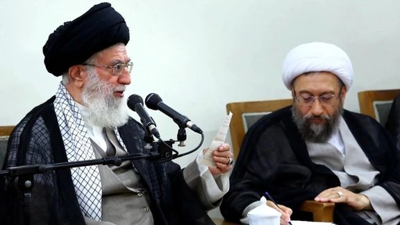 Amoli-Larijani sitting next to Ali Khamenei. Undated