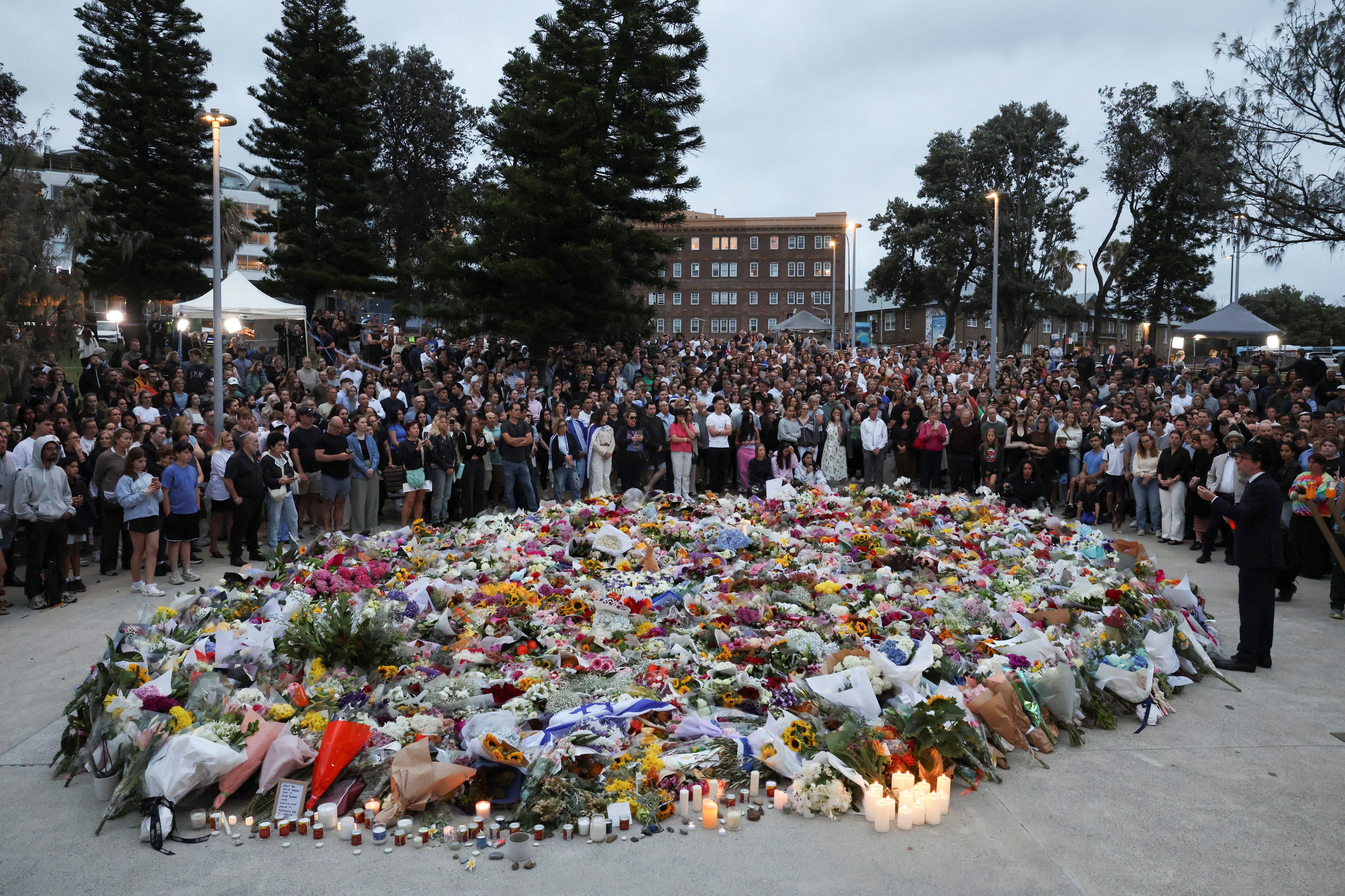 People pay respects at Bondi Pavilion to victims of a shooting during a Jewish holiday celebration at Bondi Beach, in Sydney, Australia, December 15, 2025.
