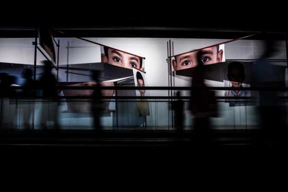 Visitors at a book fair in Tehran pass an installation showing the faces of children killed in the Minab school attack in the early hours of US-Israeli strikes on Iran