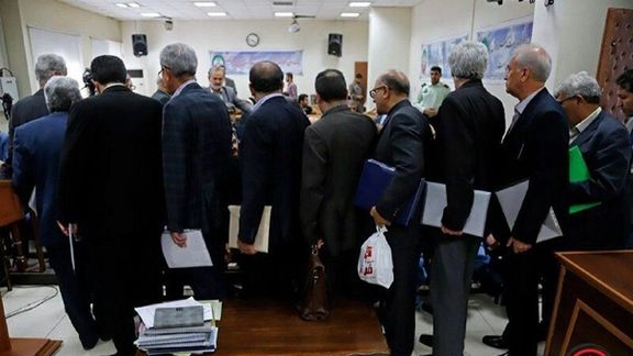People stand in line inside a bank