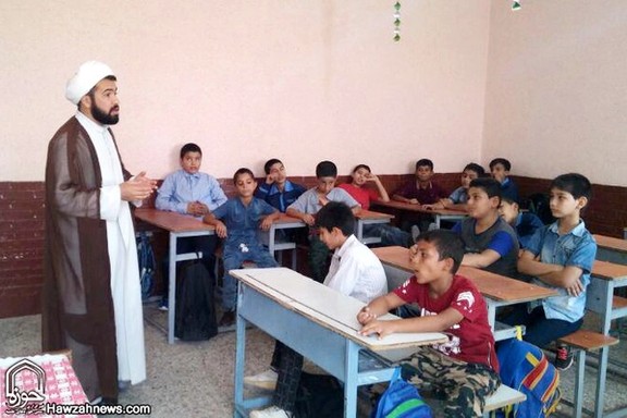 A cleric teaching a class n an Iranian elementary school