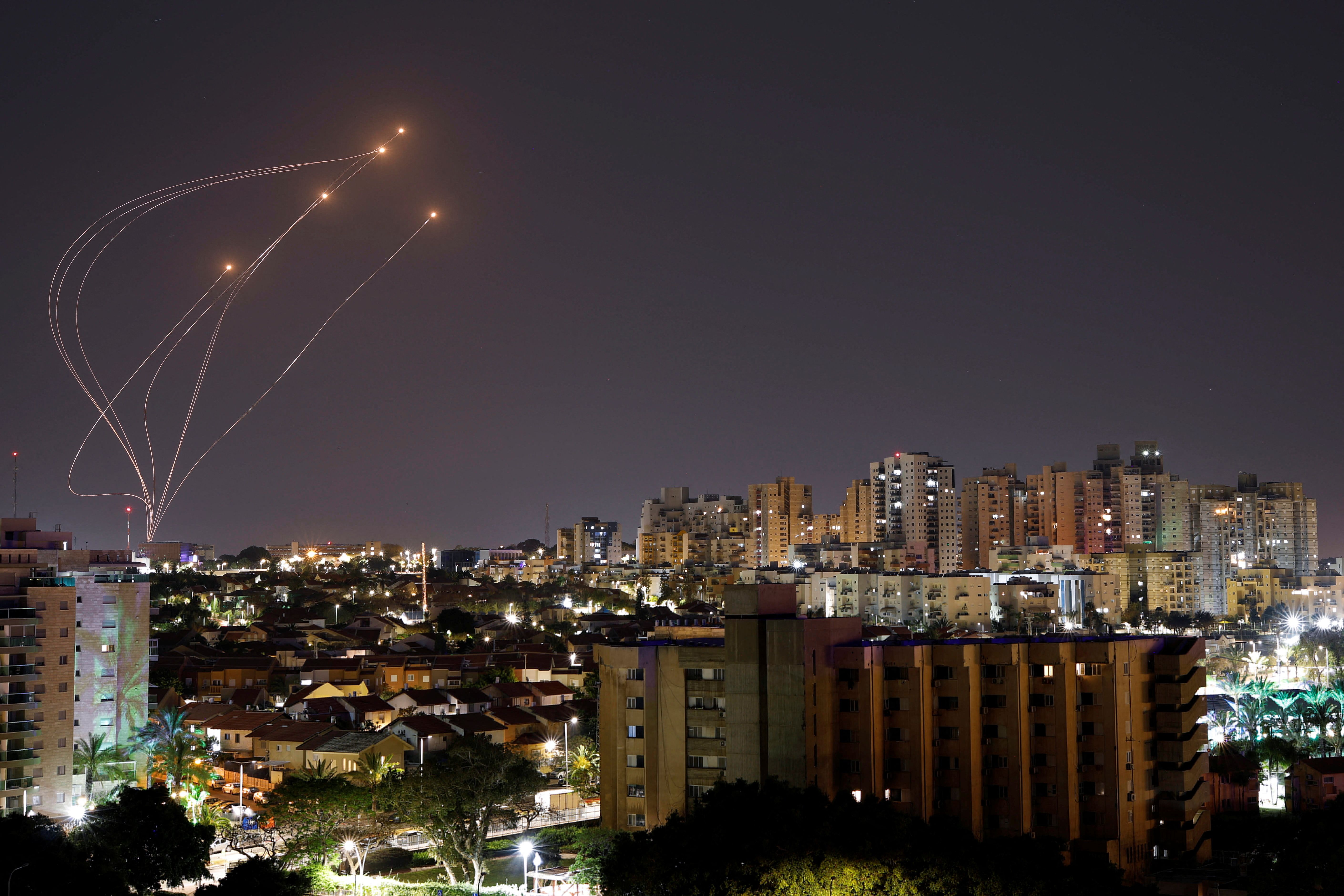 Streaks of light are seen as Israel's Iron Dome anti-missile system intercept rockets launched from the Gaza Strip, as seen from Ashkelon, April 7, 2023
