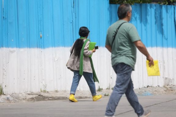An Iranian woman walks on a street amid the implementation of the new hijab surveillance in Tehran