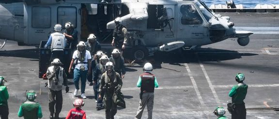 Sailors from the Dwight D. Eisenhower Carrier Strike Group assist distressed mariners rescued from the Liberian-flagged, Greek-owned bulk carrier M/V Tutor that was attacked by Houthis, in the Red Sea, June 15, 2024.