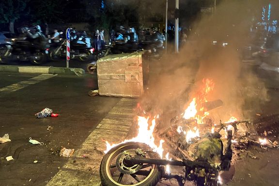 Protesters set fire to a motorcycle of security forces in Tehran on September 19, 2022