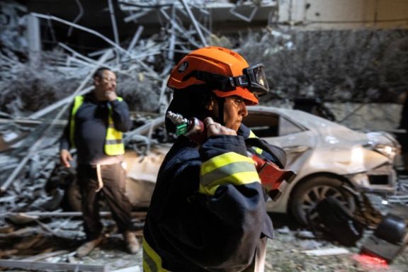Rescue personnel work at an impact site following missile attack from Iran on Israel, in Ramat Gan, Israel June 13, 2025