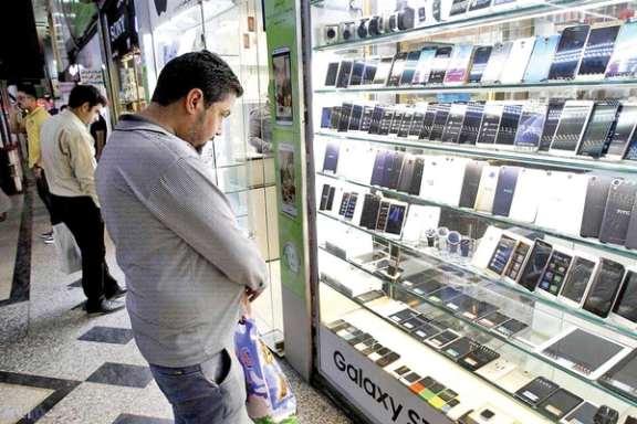 People looking at cellphone shops in Tehran