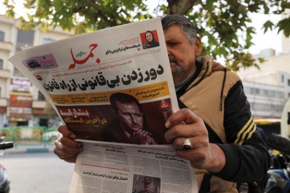 An Iranian man reads a newspaper with a picture of Syrian President Bashar al-Assad in Tehran, Iran December 8, 2024.
