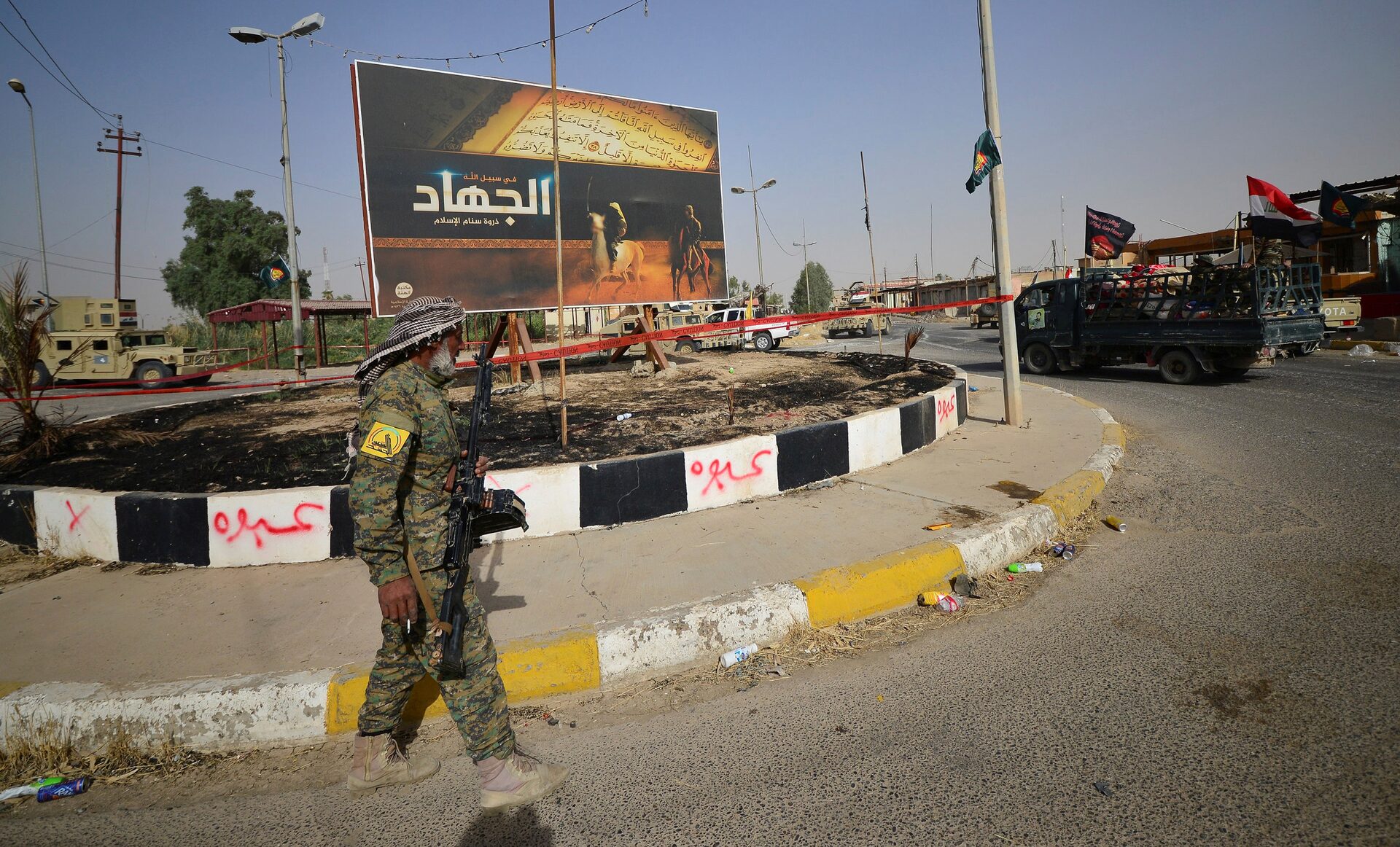 A member of Shia Popular Mobilization Forces walks on the street, after liberating the city Hawija.