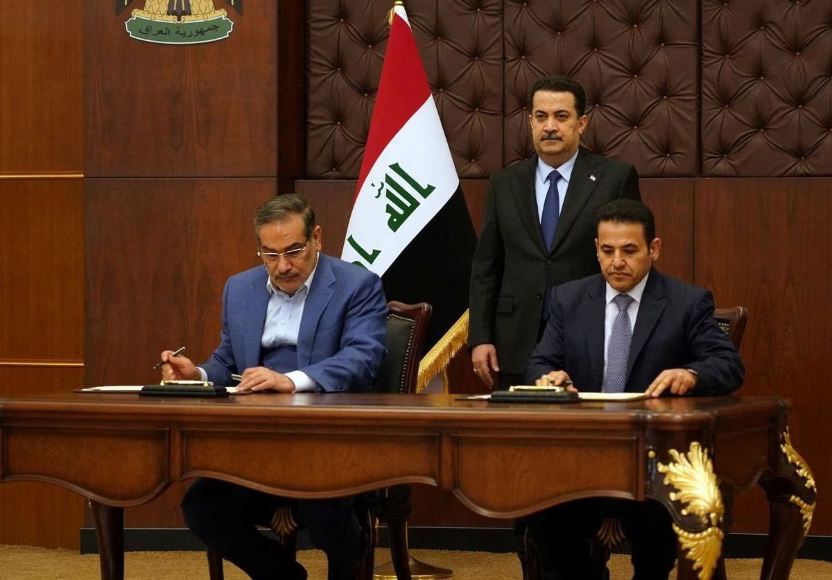  Iraqi Prime Minister Mohammed Shia al-Sudani looks on as Iraq's National Security Adviser Qasim al-Araji and Iran's Supreme National Security Council secretary Ali Shamkhani sign the security agreement that includes coordination in protecting the common borders between the two countries, in Baghdad, Iraq, March 19, 2023. 