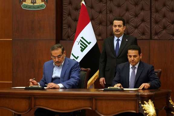 Iraqi Prime Minister Mohammed Shia al-Sudani looks on as Iraq's National Security Adviser Qasim al-Araji and Iran's Supreme National Security Council secretary Ali Shamkhani sign the security agreement that includes coordination in protecting the common borders between the two countries, in Baghdad, Iraq, March 19, 2023.