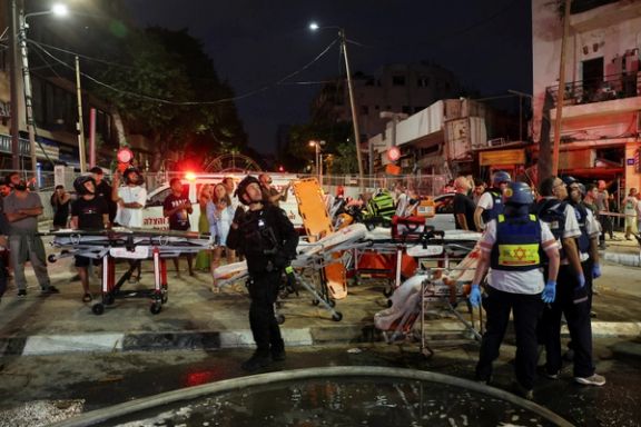 Firefighters and rescue personnel work at an impact site following missile attack from Iran on Israel, in Tel Aviv, June 16 2025.