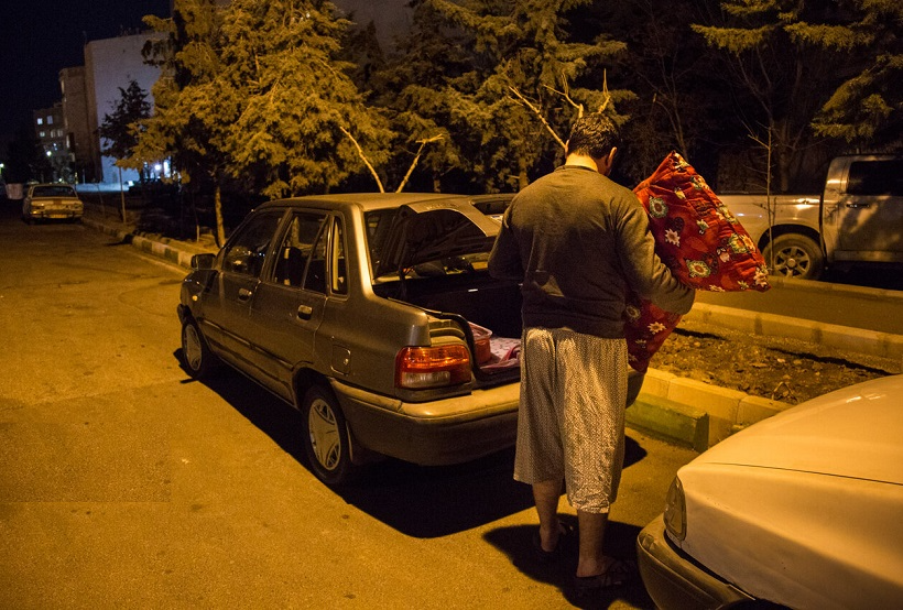 An internet taxi driver preparing to sleep in his car (Undated)